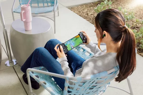 椅子上的一个女孩玩Genshin对Razer Kishi V3 Pro Controller的影响